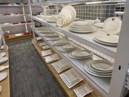 Plates, platters and square dishes racked along an aisle in the Pasay City showroom